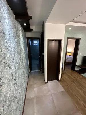 a hallway with two doors and a room with a bedroom at Nomakop5 in Kopaonik