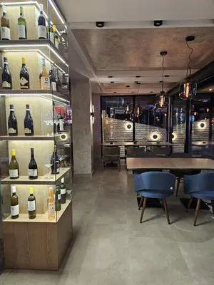 a wine store with a table and some bottles of wine at Nomakop5 in Kopaonik