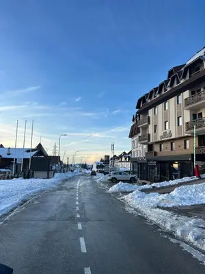 an empty street in a town covered in snow at Nomakop5 in Kopaonik