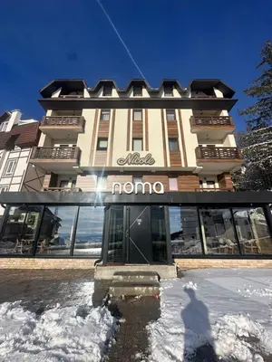 a building with a nomo sign on the front of it at Nomakop5 in Kopaonik