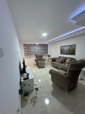 a living room with two couches and a table at Best Deal Suite in Niš
