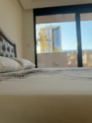 a close up of a bed in a room with a window at Best Deal Suite in Niš