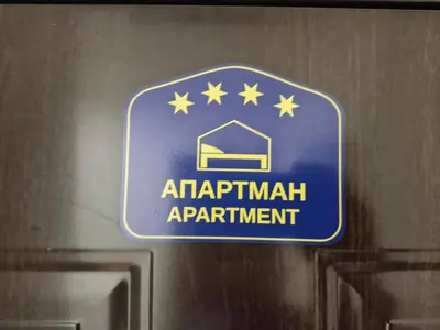a blue sign on a door with stars on it at Apartman Leskovac in Leskovac