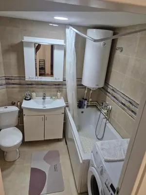 a bathroom with a toilet and a tub and a sink at Apartman Leskovac in Leskovac