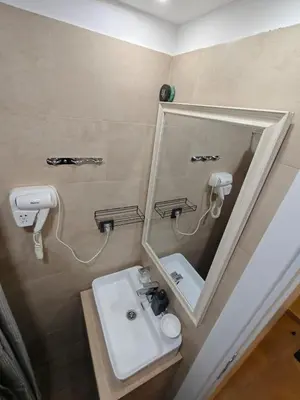 a bathroom with a mirror and a sink at Apartments Kos - Milmari Resort in Kopaonik