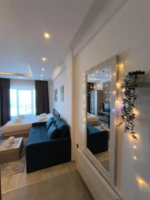 a bedroom with a bed and a large mirror at Apartments Kos - Milmari Resort in Kopaonik