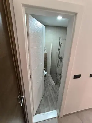 a bathroom with a shower and a glass door at Apartments Kos - Milmari Resort in Kopaonik