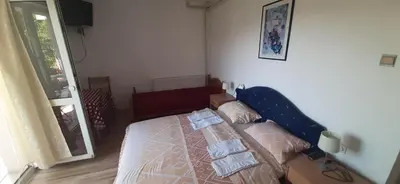 a bedroom with a bed with towels on it at Apartments Nebojša in Soko Banja
