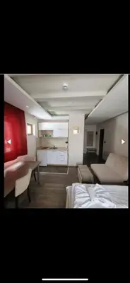 a room with two beds and a couch and a table at Nikola Milmari in Kopaonik