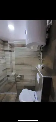 a bathroom with a white toilet in a room at Nikola Milmari in Kopaonik