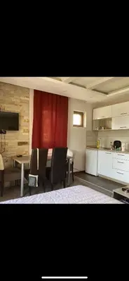 a kitchen and dining room with a table and chairs at Nikola Milmari in Kopaonik