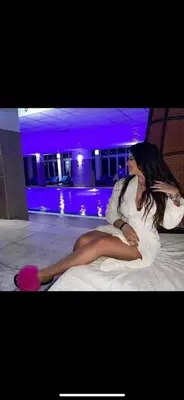a woman laying on a bed in a room at Nikola Milmari in Kopaonik