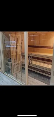 a glass window in a room with wooden walls at Nikola Milmari in Kopaonik