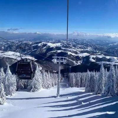 a ski lift on top of a snow covered mountain at Apartman Glečer Vila Bela Reka in Brzeće