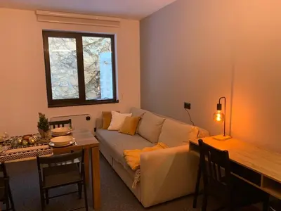 a living room with a couch and a table at Apartman Glečer Vila Bela Reka in Brzeće
