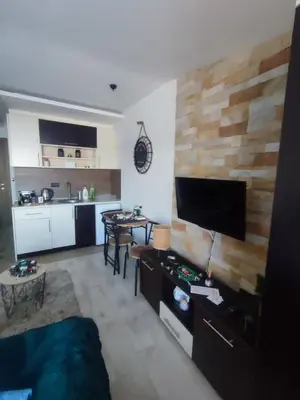 a living room with a couch and a kitchen at Milmari kop in Raška