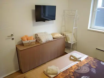 a room with a bed and a flat screen tv at CVETIĆ apartman in Zaječar