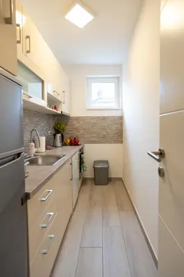 a small kitchen with a sink and a window at CVETIĆ apartman in Zaječar
