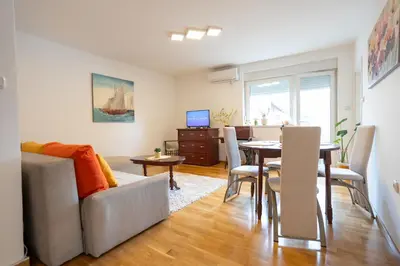 a living room with a couch and a table at CVETIĆ apartman in Zaječar