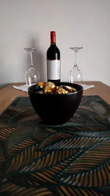 a bottle of wine and two glasses on a table at Planinski kutak Residence Hill in Kopaonik