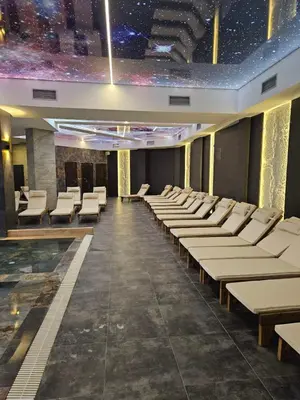 a large room with white chairs and a star ceiling at Planinski kutak Residence Hill in Kopaonik