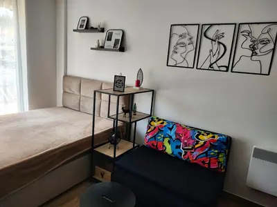 a bedroom with a bed and a chair in it at Planinski kutak Residence Hill in Kopaonik