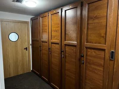 a locker room with wooden cabinets and a door at Z3 Studio in Kopaonik