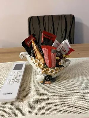 a bowl of snacks on a table next to a remote control at Apartman KVINS 1 in Kruševac
