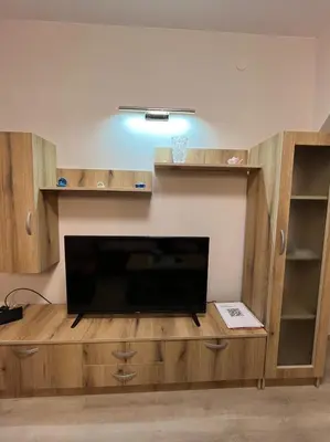a living room with a large entertainment center with a flat screen tv at Apartman KVINS 1 in Kruševac