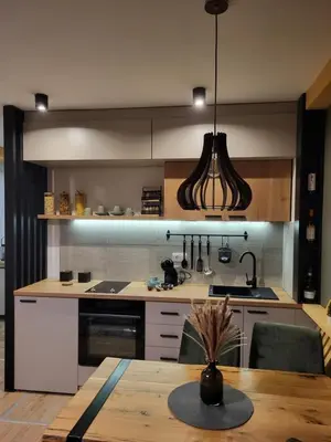 a kitchen with a wooden table and a dining room at Hera Kopaonik in Kopaonik