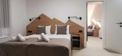 a bedroom with a large bed with white pillows at Vučja reka in Crni Vrh