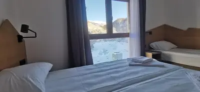 a bedroom with a bed and a large window at Vučja reka in Crni Vrh