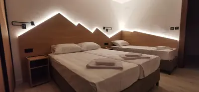 two beds in a small room with two towels on them at Vučja reka in Crni Vrh