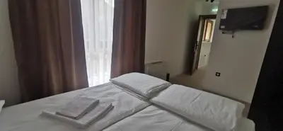 a bedroom with a bed with two towels on it at Vučja reka in Crni Vrh
