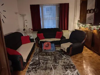 a living room with two couches and a table at Apartman Trijumf in Vrnjačka Banja