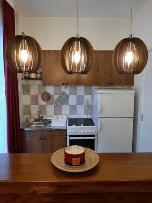 a kitchen with a table with a bowl on top of it at Apartman Trijumf in Vrnjačka Banja