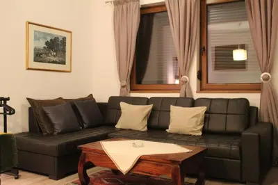 a living room with a couch and a coffee table at Kopaonik apartman Miklušev in Kopaonik
