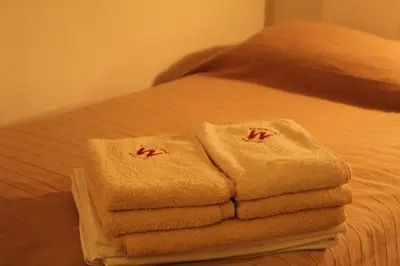 a pile of towels sitting on top of a bed at Kopaonik apartman Miklušev in Kopaonik