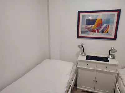 a bedroom with a bed and a nightstand with two lamps at Kopaonik apartman Miklušev in Kopaonik