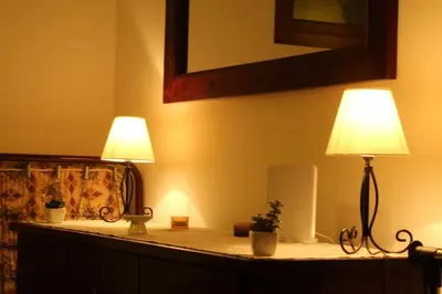 two lamps on top of a table with a mirror at Kopaonik apartman Miklušev in Kopaonik