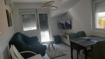 a living room with a couch and a table at Četiri dragulja in Soko Banja