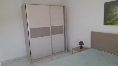 a sliding glass door in a bedroom with a bed at Četiri dragulja in Soko Banja