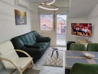 a living room with a couch and a table at Četiri dragulja in Soko Banja