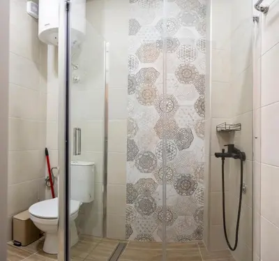 a bathroom with a shower with a toilet at Encanto room in Niš