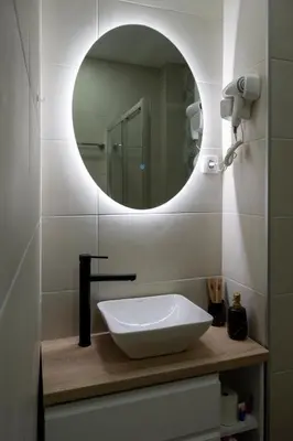 a bathroom with a white sink and a mirror at Encanto room in Niš