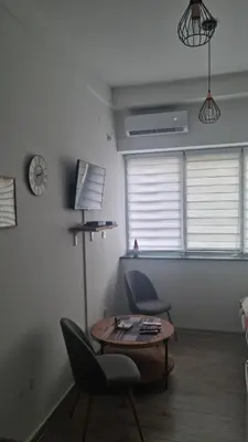 a living room with a table and two chairs at Encanto room in Niš