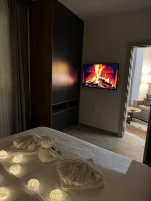a bedroom with a bed with a teddy bear on it at Friends Apartmani - Broj 2 in Raška