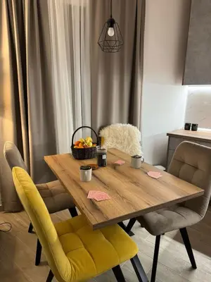 a dining room table with a bowl of fruit on it at Friends Apartmani - Broj 2 in Raška