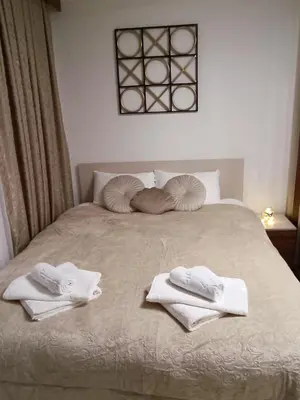 a bed with towels on top of it at Sunčana planina apartman 104 in Kopaonik