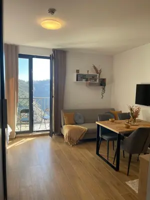 a living room with a couch and a table at Apartman Lawa Kopaonik in Kopaonik